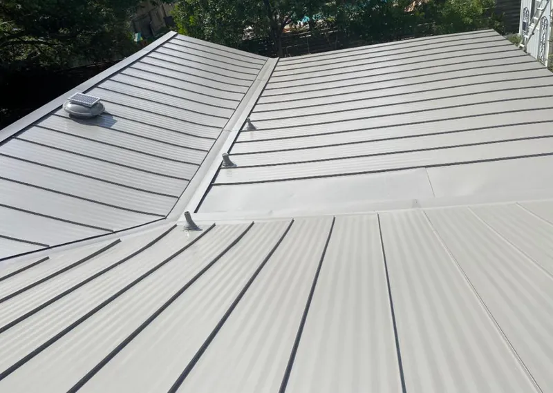 Solar attic fan installed on a metal roof for Roof Ventilation in Cleveland
